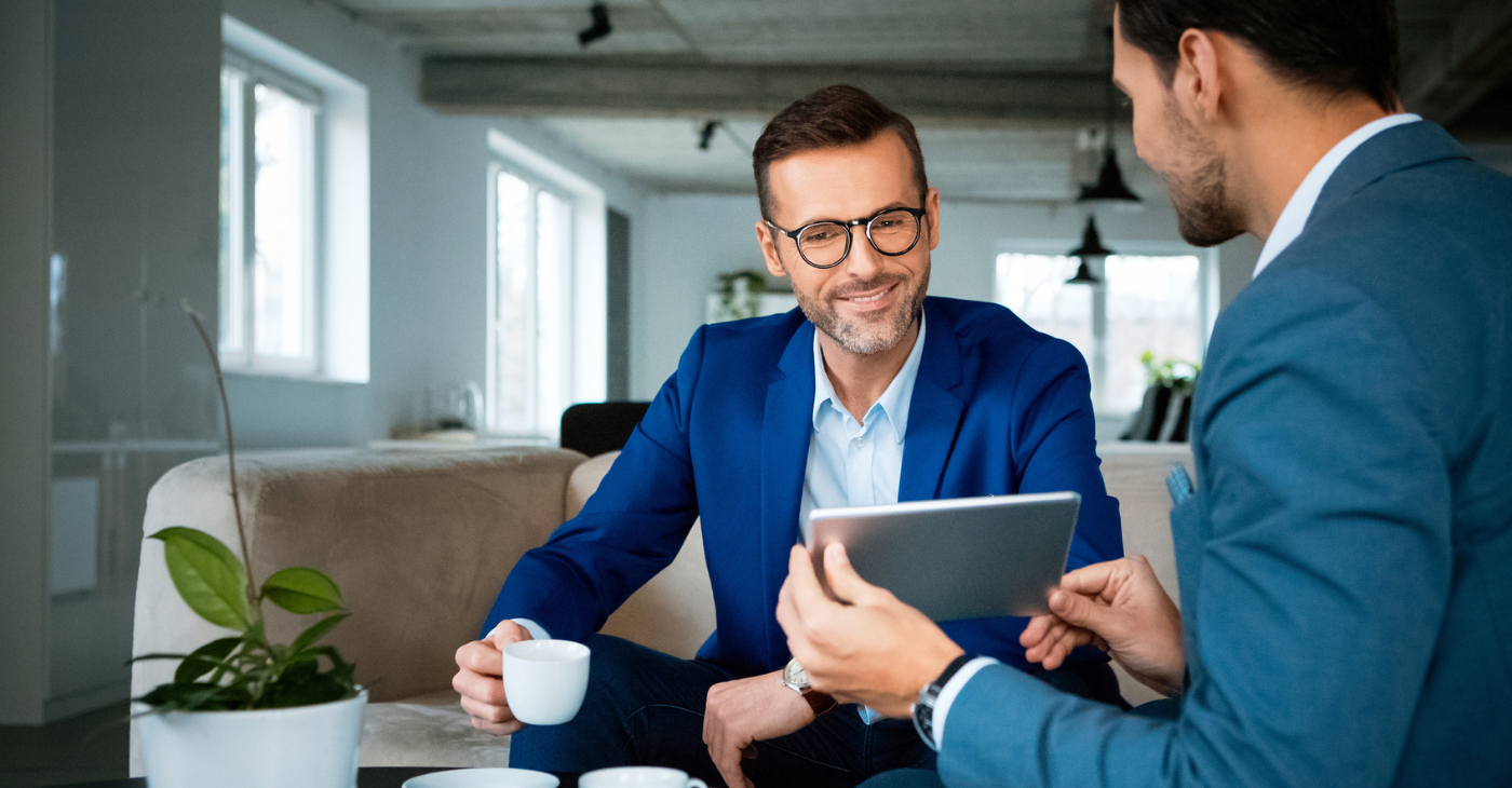 A smart, friendly agent sitting with a landlord