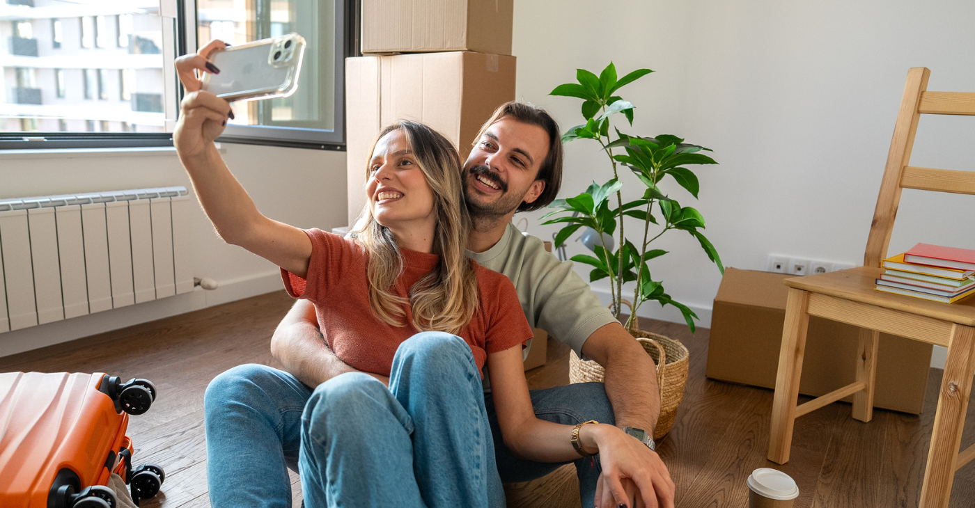 Couple taking a picture in their new home